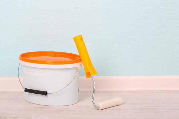 Paint roller and bucket in a room being painted